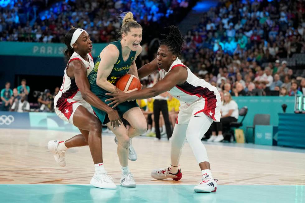 Sami Whitcomb (32), of Australia, drives under the pressure from United States' Jackie Young (1 ...