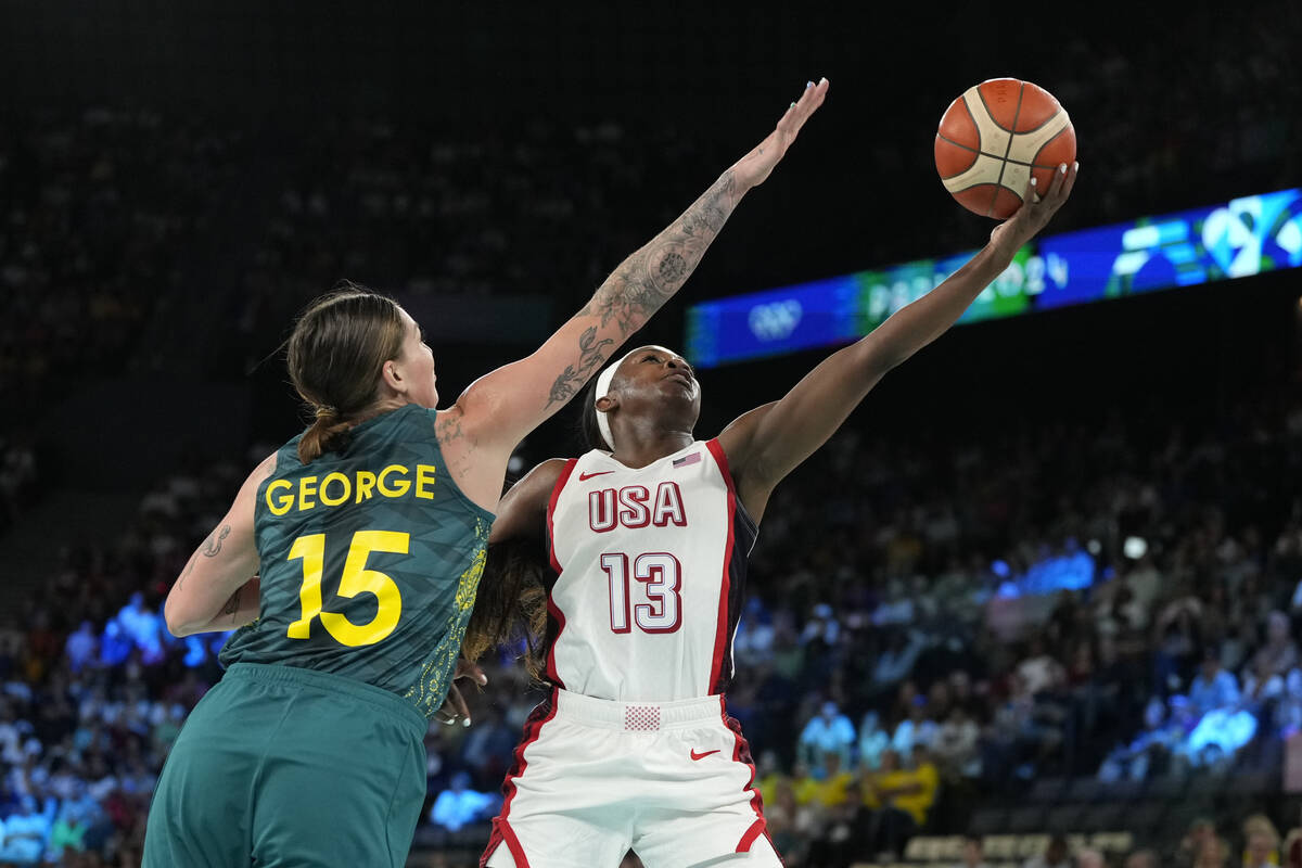 Cayla George (15), of Australia, attempts to block the shot of United States' Jackie Young (13) ...