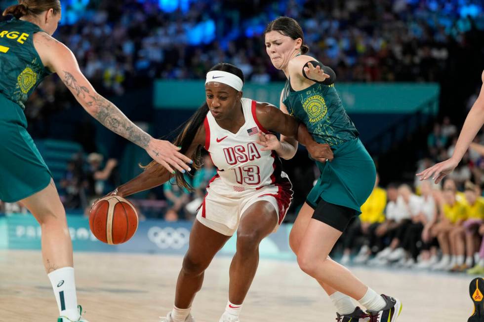 United States' Jackie Young (13) drives past Jade Melbourne (2), of Australia, during a women's ...