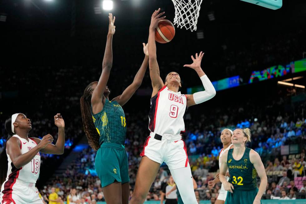 Ezi Magbegor (13), of Australia, and United States' A'ja Wilson (9) go for a rebound during a w ...