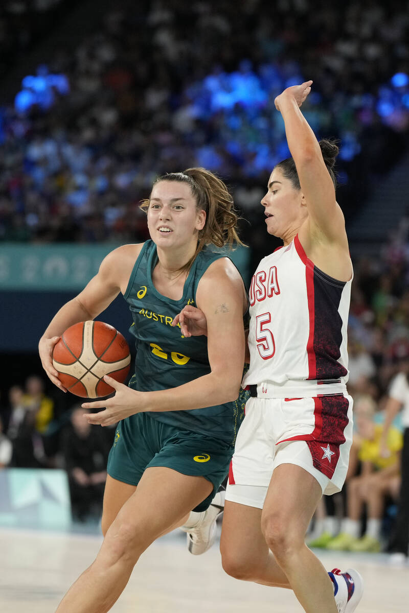 Isobel Borlase (20), of Australia, drives with the ball past United States' Kelsey Plum (5) dur ...