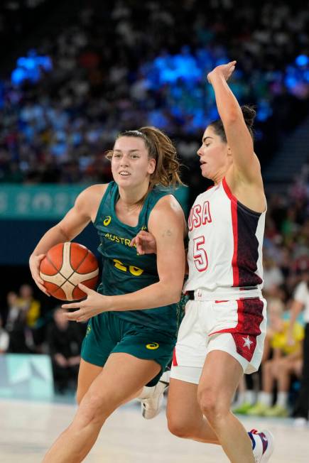 Isobel Borlase (20), of Australia, drives with the ball past United States' Kelsey Plum (5) dur ...