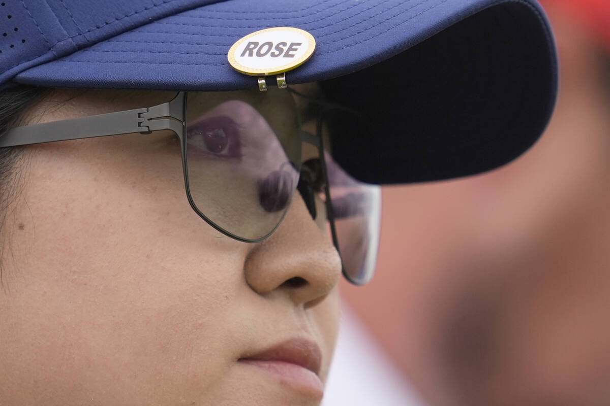 Rose Zhang, of the United States, looks down the 12th hole from the tee, she is wearing a name ...