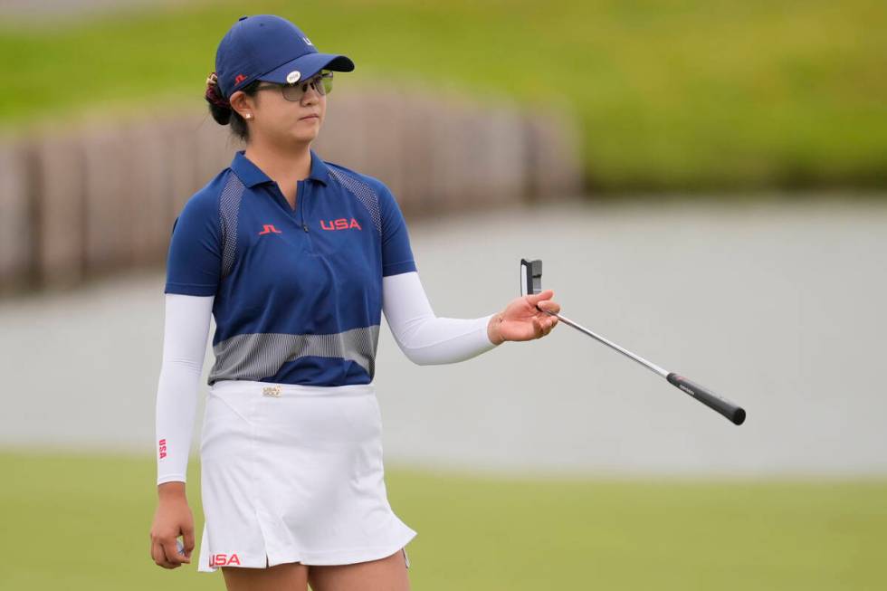 Rose Zhang, of the United States, hands her club to her caddie on the 2nd green during the thir ...