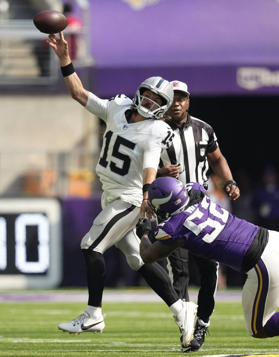 Las Vegas Raiders quarterback Gardner Minshew II (15) is hit by Minnesota Vikings linebacker Ji ...