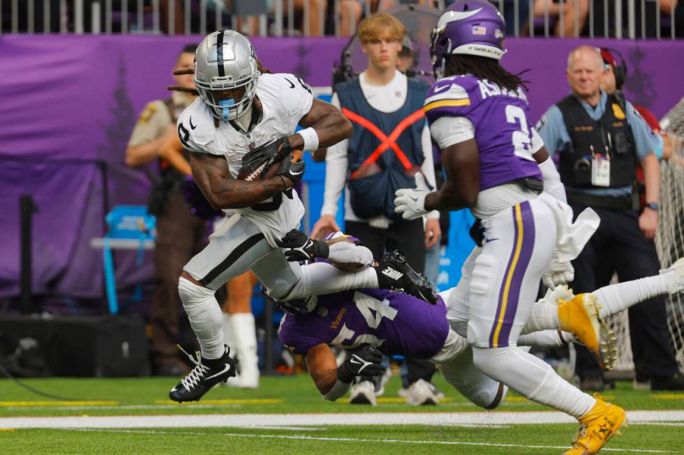 Las Vegas Raiders running back Ameer Abdullah (8) runs over Minnesota Vikings linebacker Kamu G ...