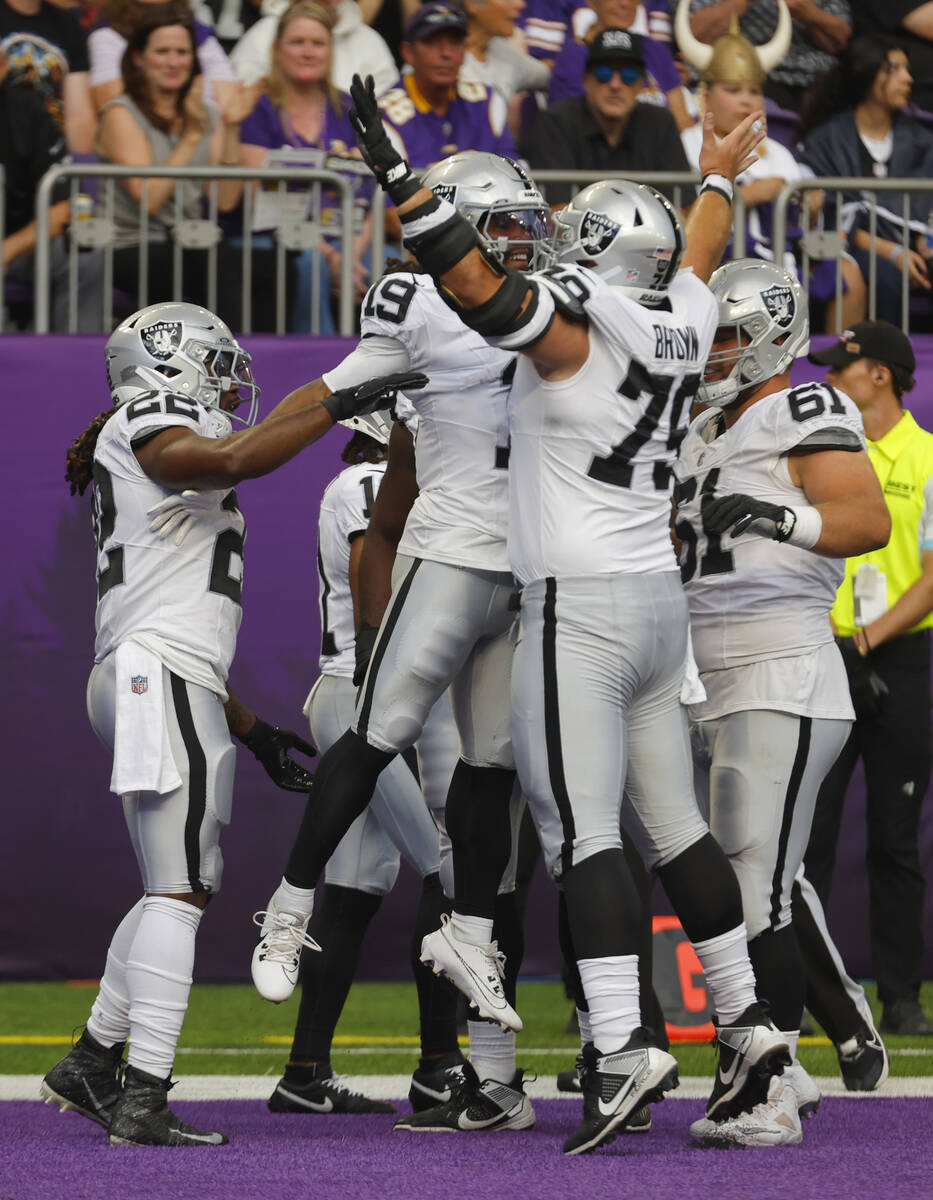 Las Vegas Raiders wide receiver DJ Turner (19) celebrates his touchdown with teammate Ben Brown ...