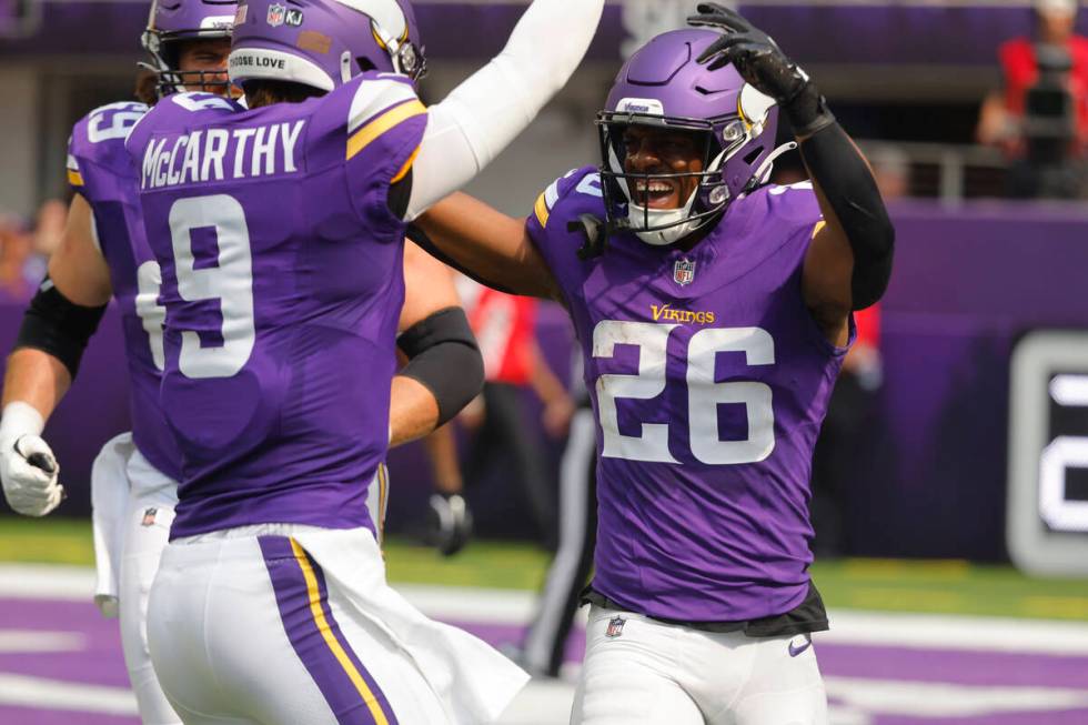 Minnesota Vikings running back Kene Nwangwu (26) celebrates his touchdown with quarterback J.J. ...