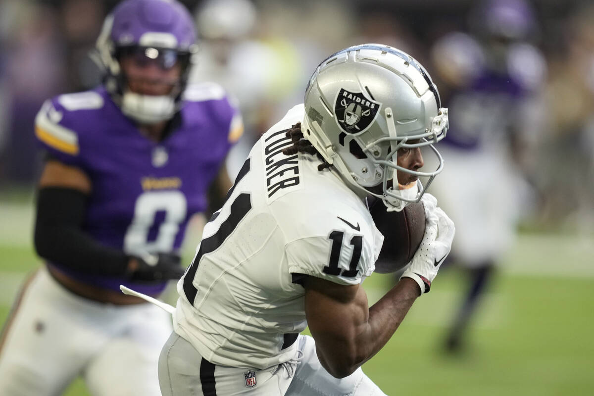 Las Vegas Raiders wide receiver Tre Tucker (11) makes a catch in front of Minnesota Vikings lin ...