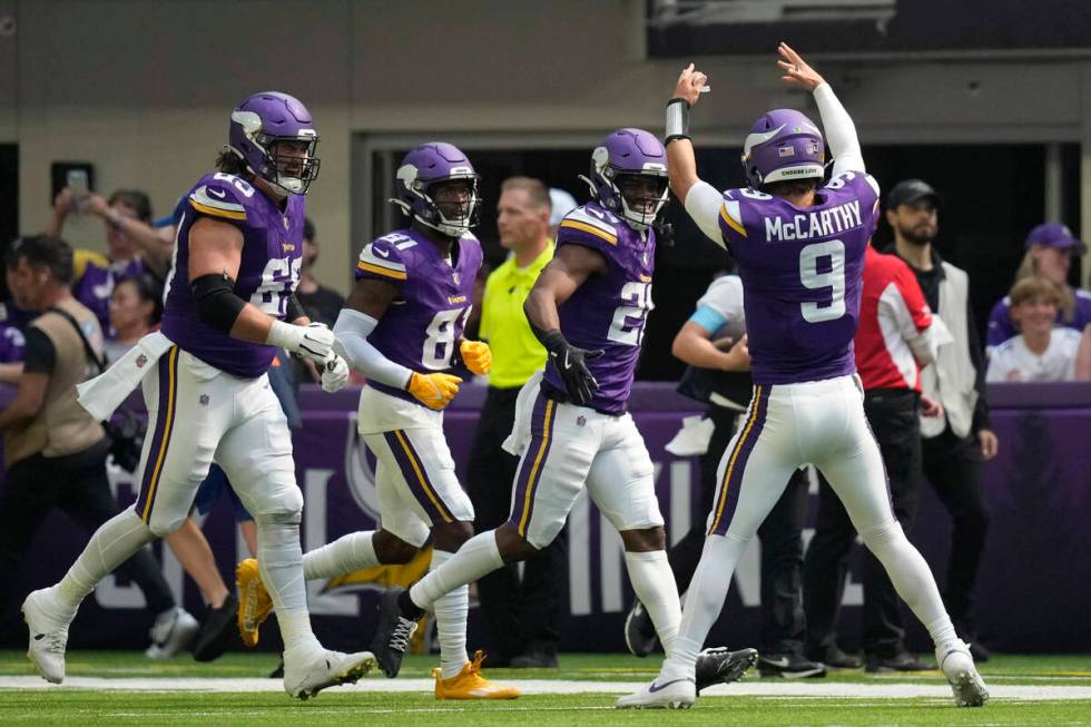 Minnesota Vikings quarterback J.J. McCarthy (9) celebrates with teammates after a touchdown aga ...