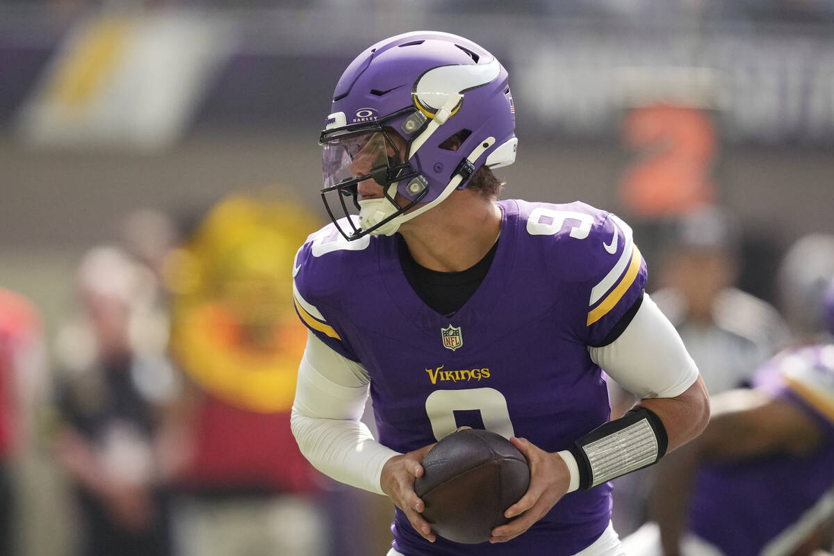 Minnesota Vikings quarterback J.J. McCarthy (9) looks to hand off during the first half of an N ...