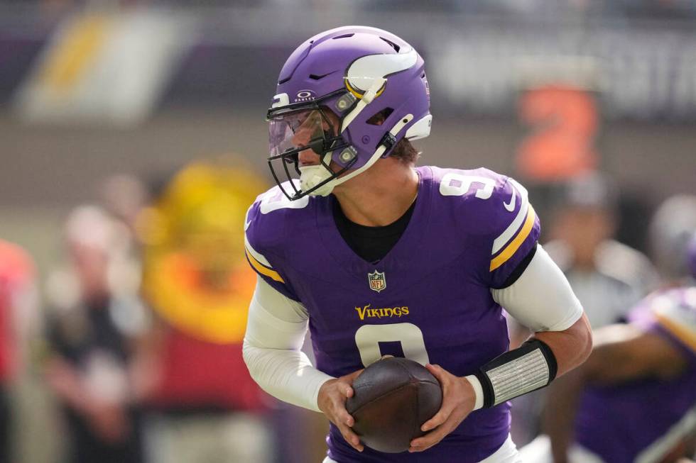 Minnesota Vikings quarterback J.J. McCarthy (9) looks to hand off during the first half of an N ...