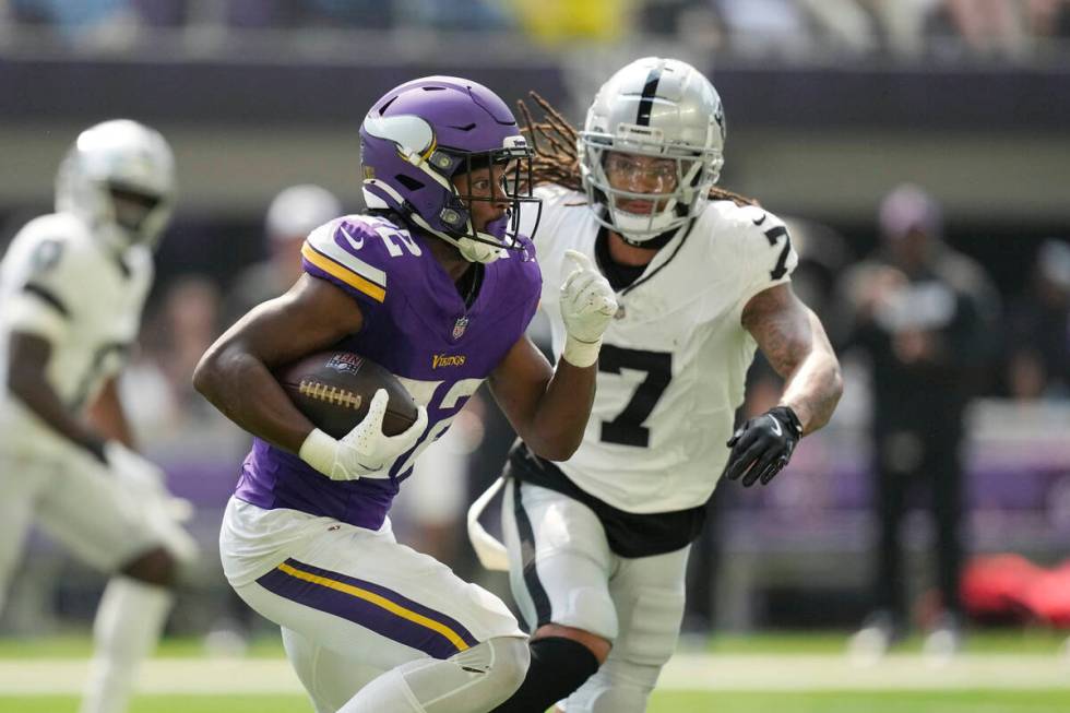 Minnesota Vikings running back Ty Chandler (32) runs against Las Vegas Raiders safety Tre'von M ...