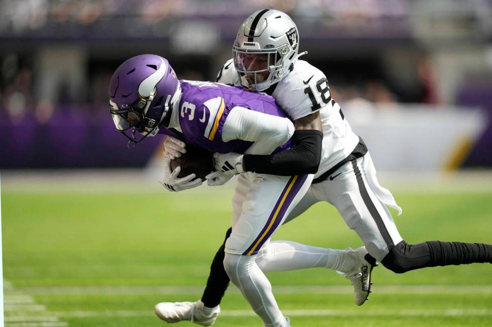 Minnesota Vikings wide receiver Jordan Addison (3) is hit by Las Vegas Raiders cornerback Jack ...