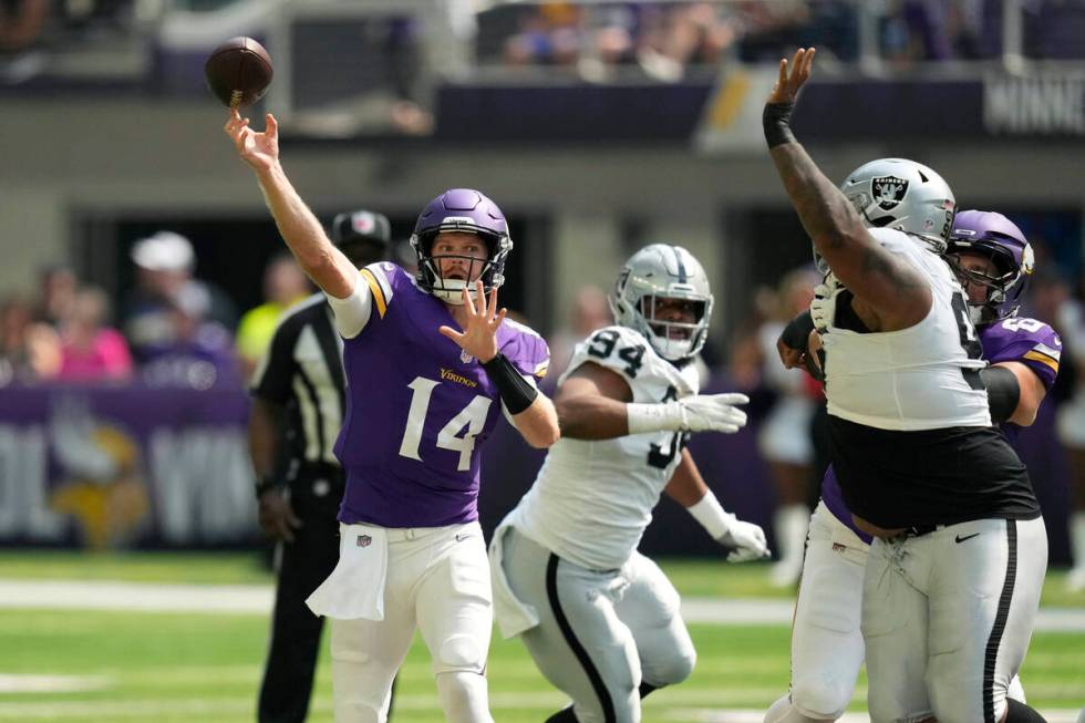 Minnesota Vikings quarterback Sam Darnold (14) throws against the Las Vegas Raiders during the ...