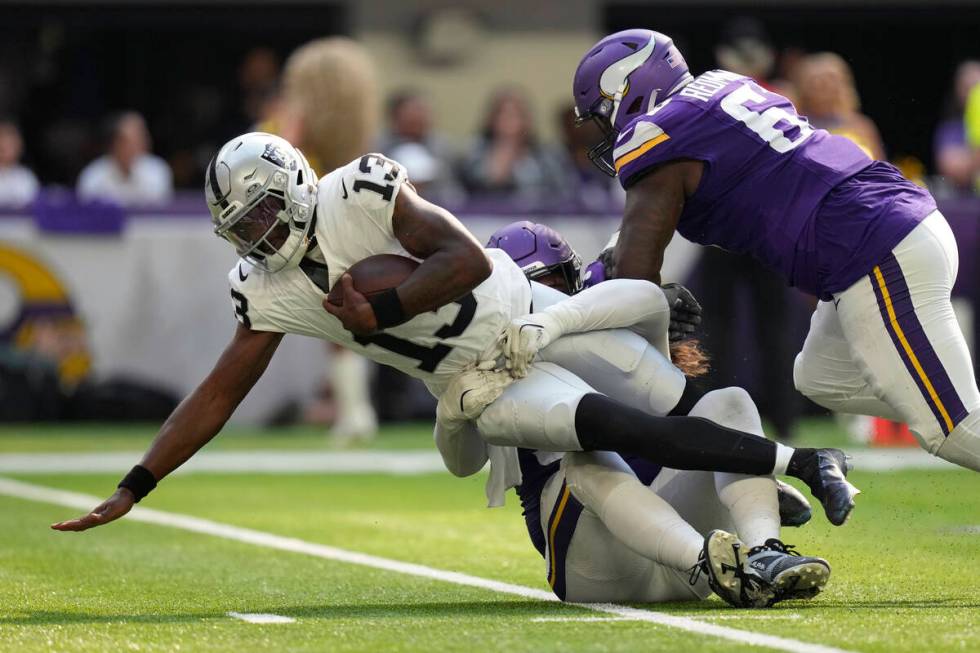 Las Vegas Raiders quarterback Anthony Brown Jr. (13) is sacked by Minnesota Vikings defensive t ...