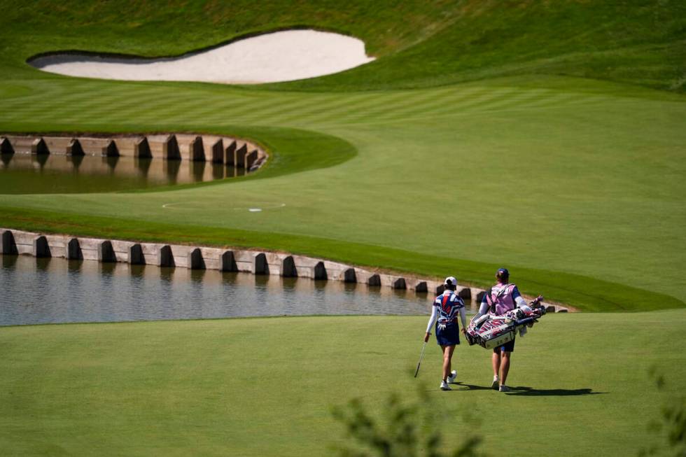 Rose Zhang, of the United States, and her caddie walk to the 1st green during the final round o ...