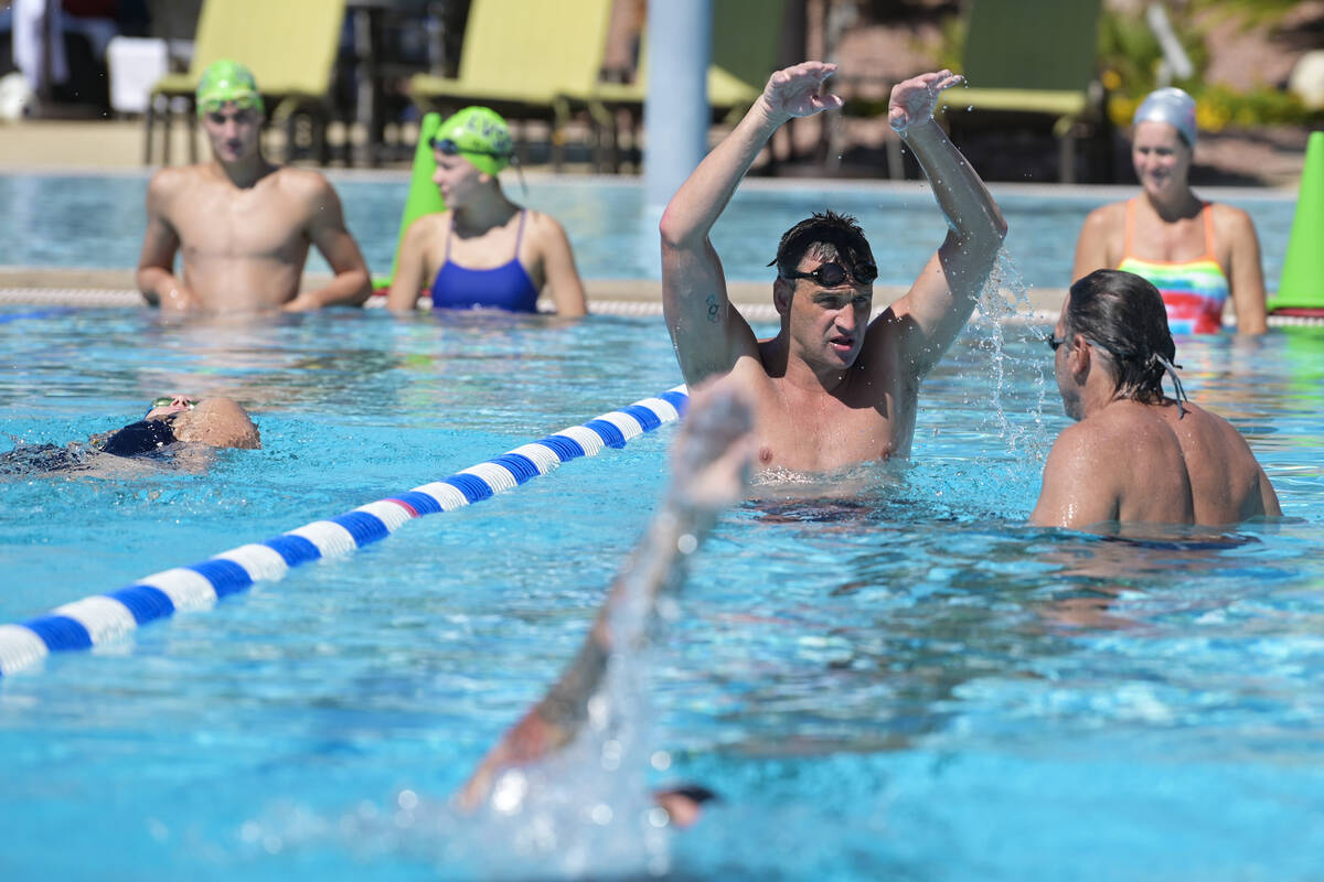 Current world record holder and 12-time Olympic medalist Ryan Lochte gives pointers during a sw ...