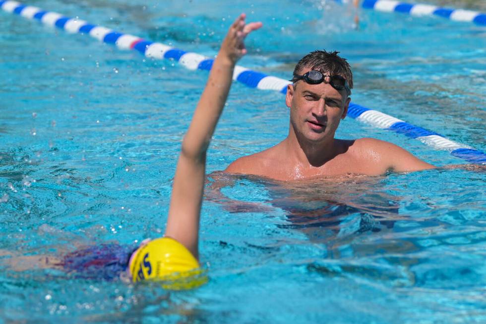 Current world record holder and 12-time Olympic medalist Ryan Lochte assesses a participant dur ...