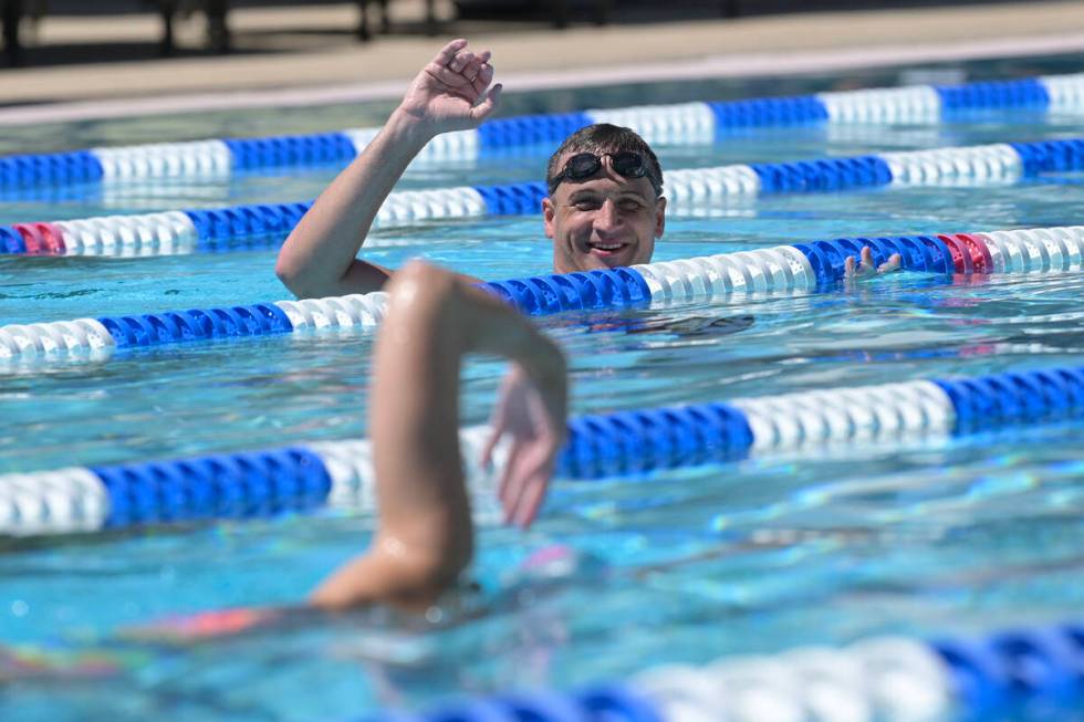 Current world record holder and 12-time Olympic medalist Ryan Lochte assesses a participant dur ...