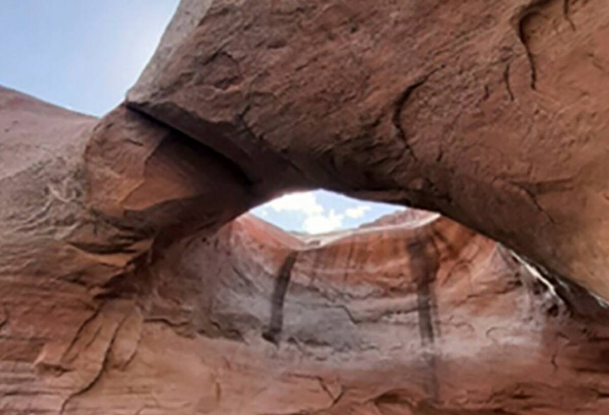 This photo shows Double Arch prior to collapse in Rock Creek Bay of the Glen Canyon National Re ...