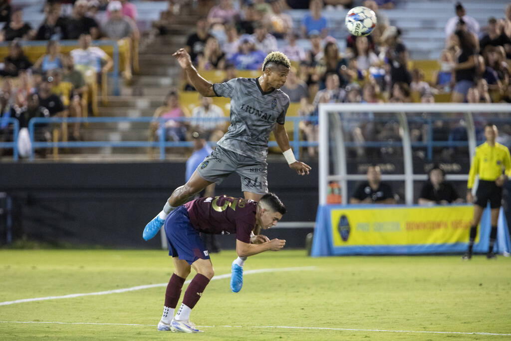 Las Vegas Lights FC defender Maliek Howell (24) headbutts the ball over Detroit City FC forward ...