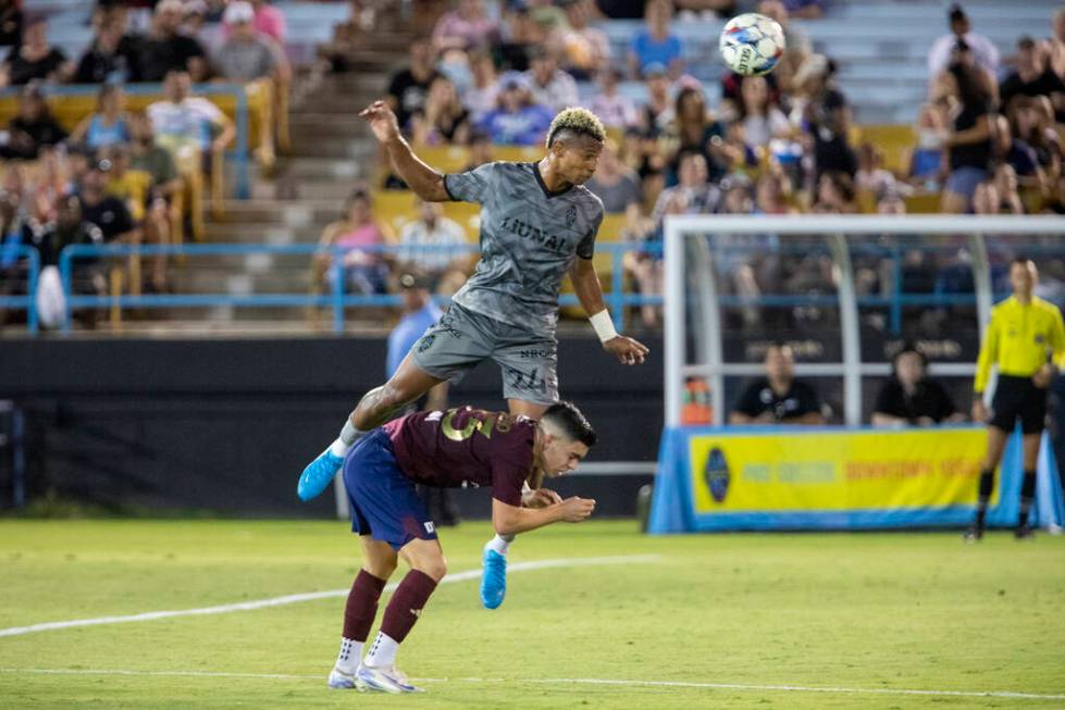 Las Vegas Lights FC defender Maliek Howell (24) headbutts the ball over Detroit City FC forward ...