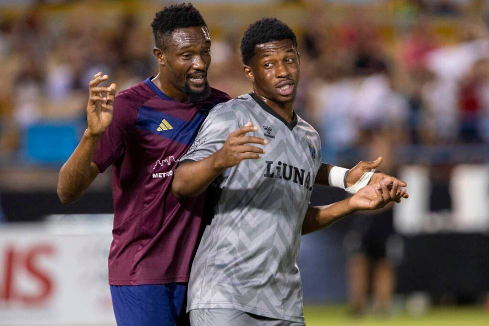 Detroit City FC forward Elvis Amoh, left, and Las Vegas Lights FC midfielder Dre Fortune, right ...