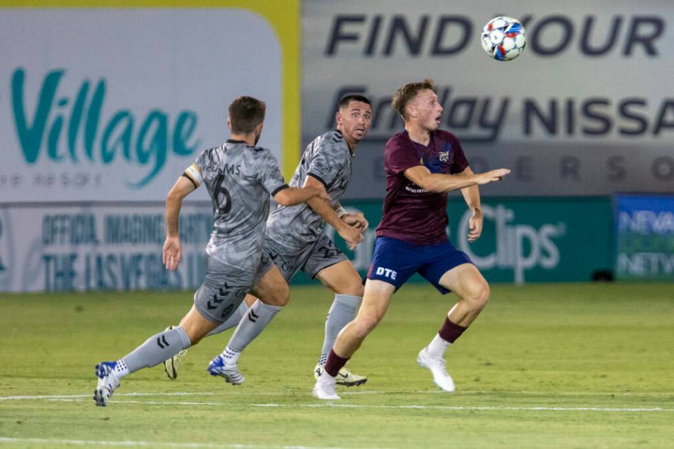 Las Vegas Lights FC defender Joe Hafferty (22) and midfielder Charlie Adams (6) run toward the ...