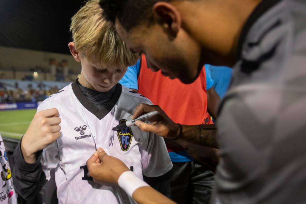 Young fans have their shirts signed by Las Vegas Lights FC players after a USL Championship soc ...