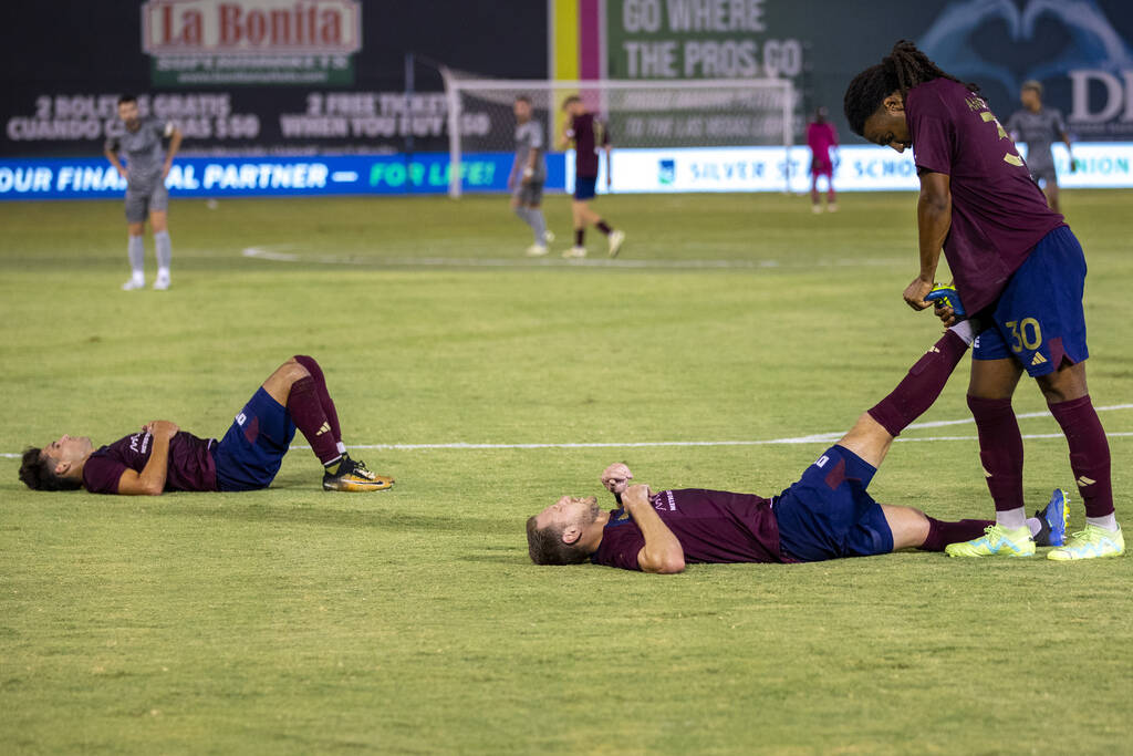 Detroit City FC players lay on the pitch as a water break is called during a USL Championship s ...