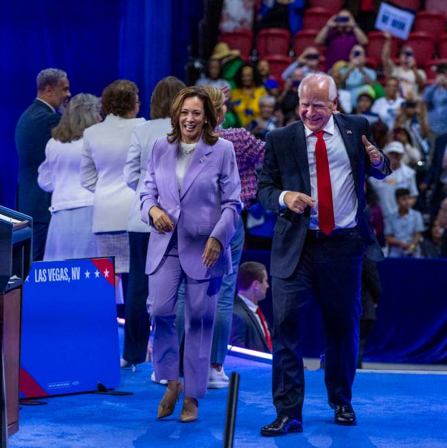 Vice President Kamala Harris and her running mate, Minnesota Gov. Tim Walz, leave the delegatio ...