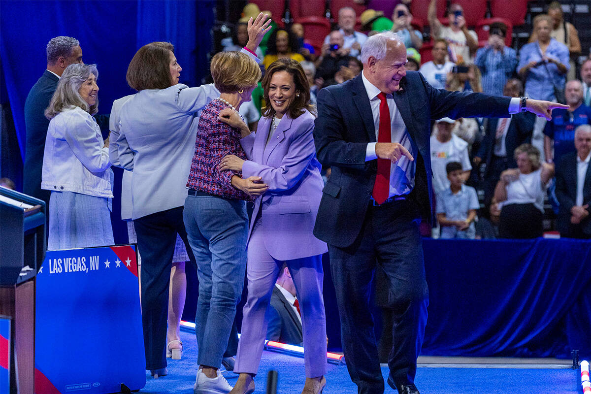 Vice President Kamala Harris and her running mate, Minnesota Gov. Tim Walz, leave the delegatio ...