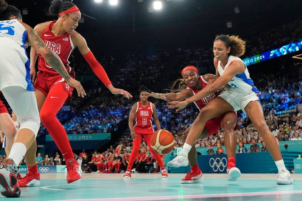 United States' Jackie Young (13) and Marieme Badiane (22), of France, go after a loose ball dur ...