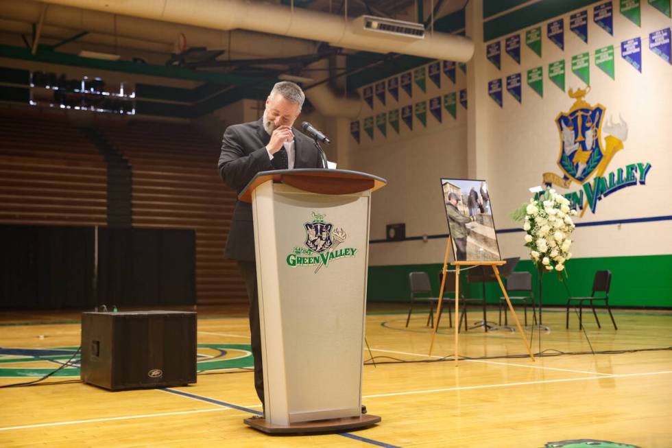 Principal Kent Roberts tears up as he speaks about Eric Johnston, a former teacher and basketba ...