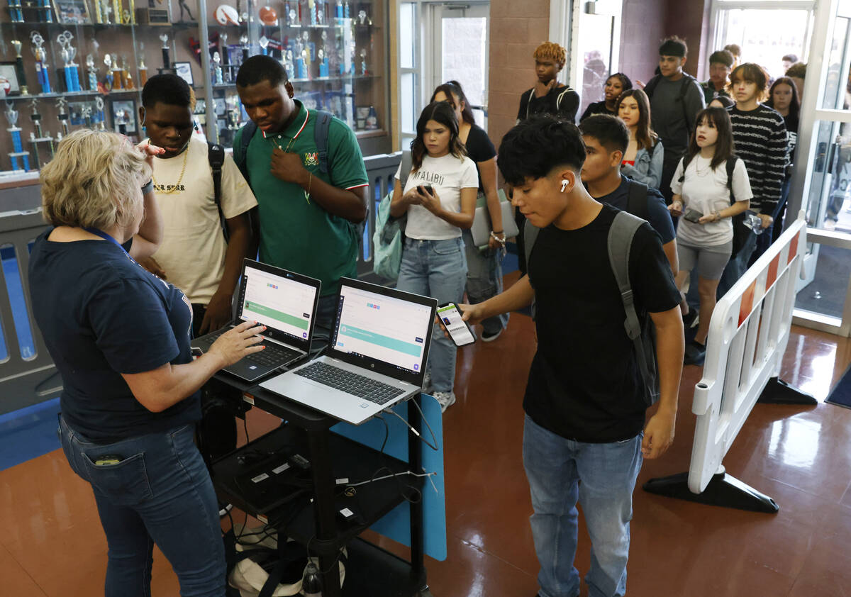 Legacy High School students line up to scan their badges during the first day of school on Mond ...