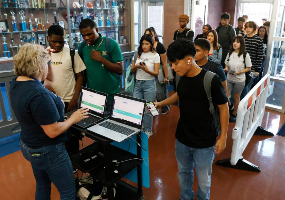 Legacy High School students line up to scan their badges during the first day of school on Mond ...