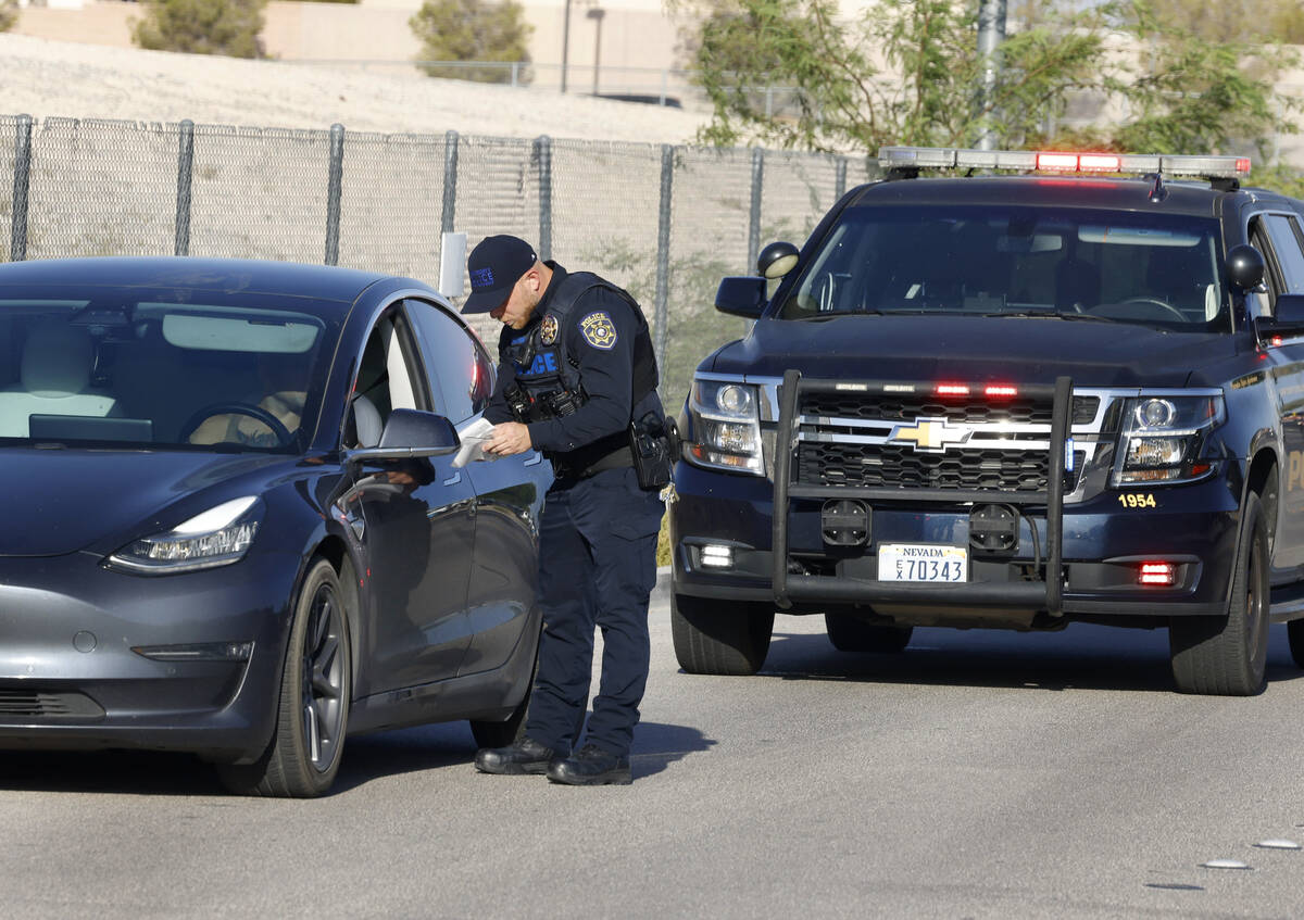 A Clark County School District police officer issues a citation to a driver who was driving ove ...