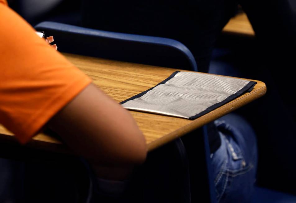 A cellphone pouch is display on Legacy High School student's desk during the first day of schoo ...