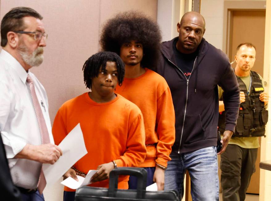 Gianni Robinson and Treavion Randolph are led into Juvenile Court for a hearing on Monday, Aug. ...