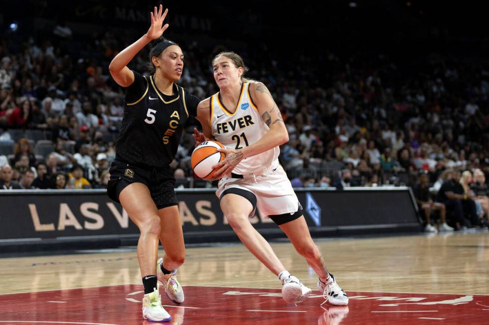 Indiana Fever forward Emily Engstler (21) drives around Las Vegas Aces forward Dearica Hamby (5 ...