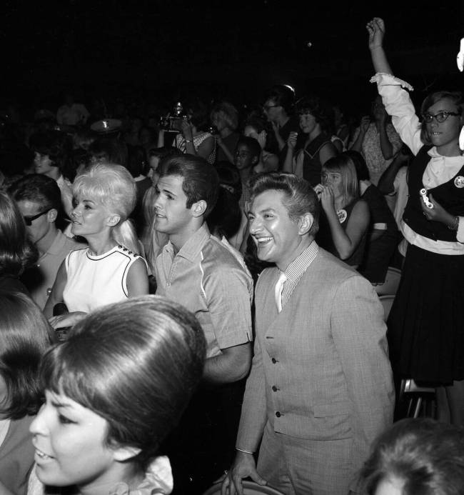 Liberace watches the Beatles perform. The band added a 4 p.m. show so entertainers who were wor ...