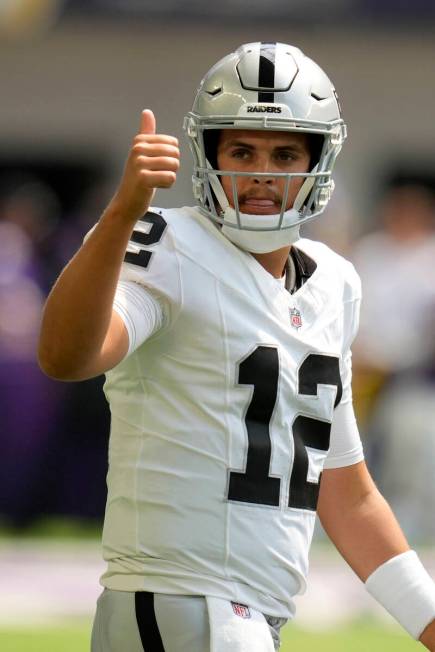 Las Vegas Raiders quarterback Aidan O'Connell walks on the field before an NFL preseason footba ...