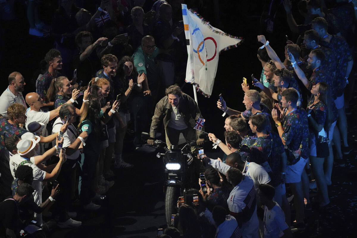 Tom Cruise rides a motorbike during the 2024 Summer Olympics closing ceremony at the Stade de F ...