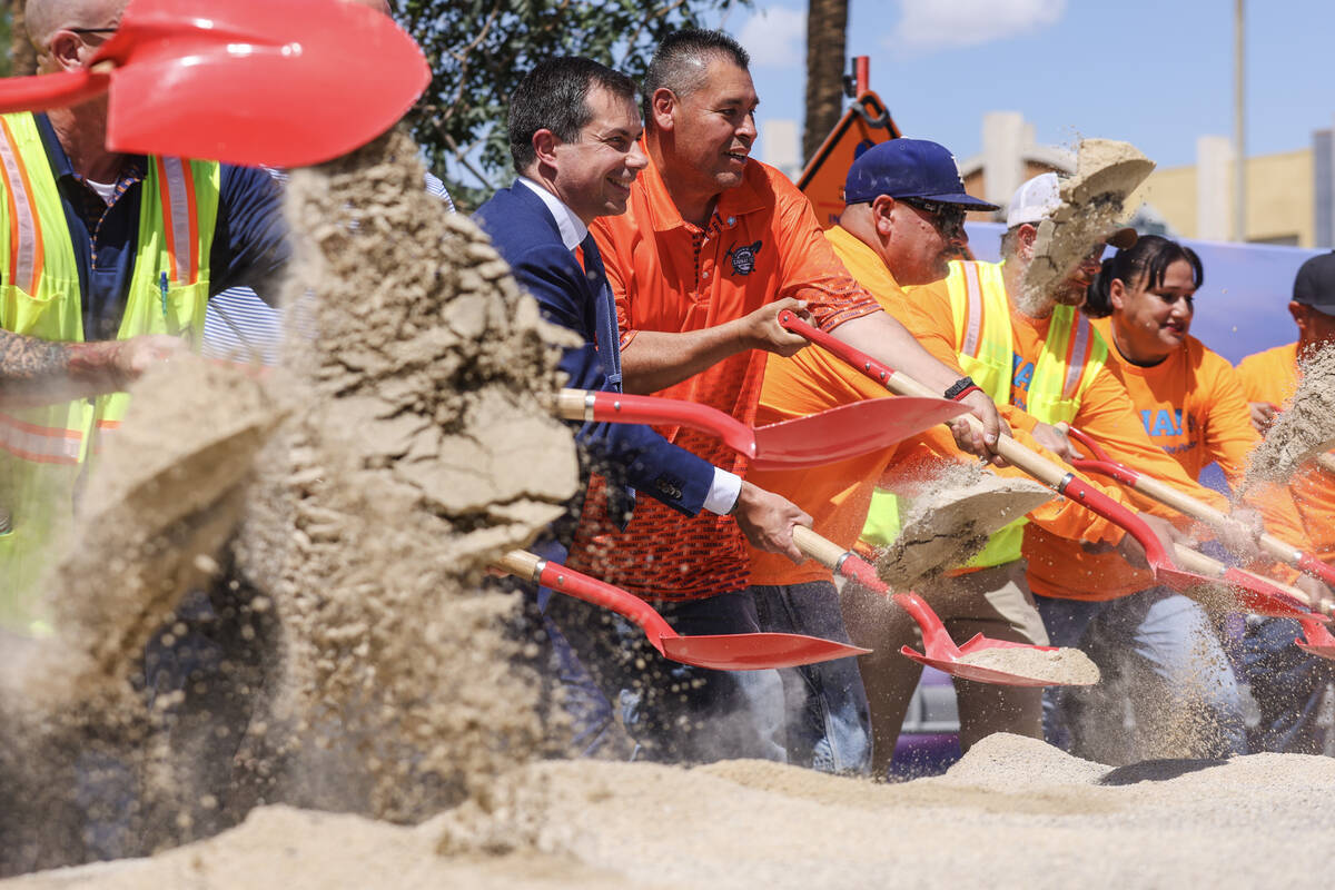 Secretary of Transportation Pete Buttigieg shovels dirt alongside members of the Local Laborers ...