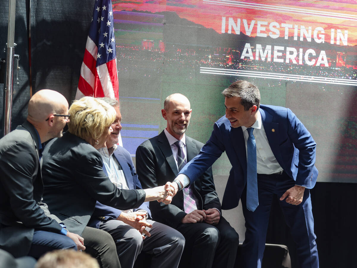 Secretary of Transportation Pete Buttigieg shakes hands with Las Vegas Mayor Carolyn Goodman a ...