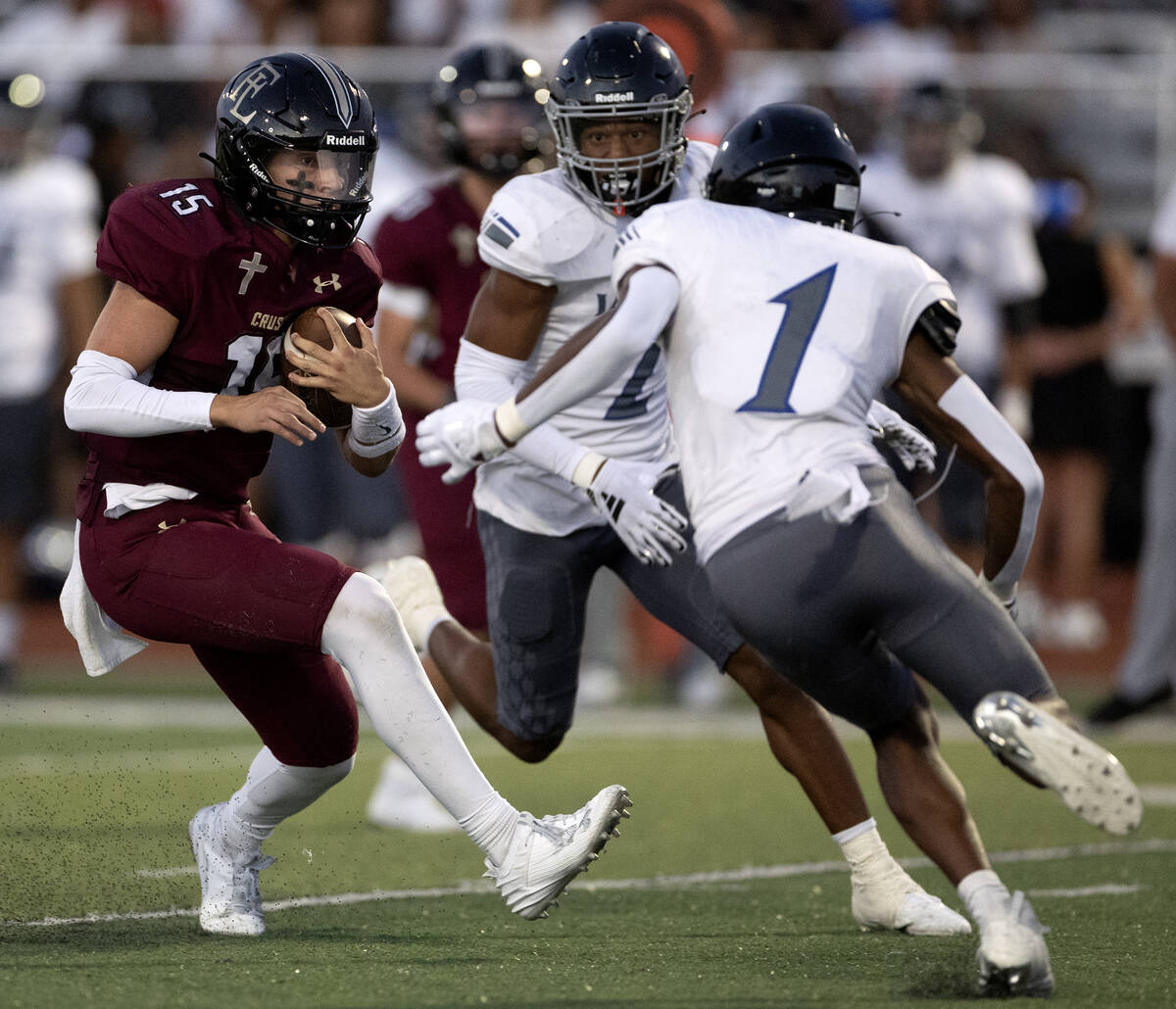 Faith Lutheran quarterback Alex Rogers (15) runs the ball while Desert Pines’ Jaylen All ...