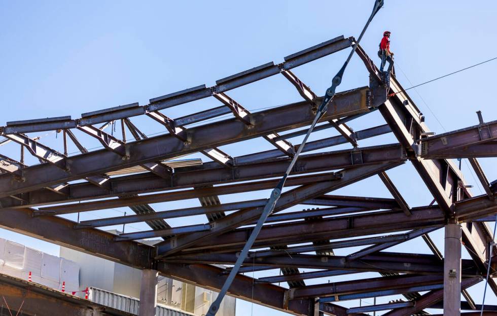 A worker up top awaits the arrival of the beam as the Las Vegas Convention and Visitors Authori ...