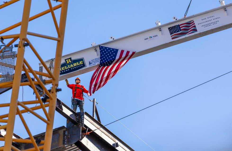 A worker guides the beam into place as the Las Vegas Convention and Visitors Authority holds a ...