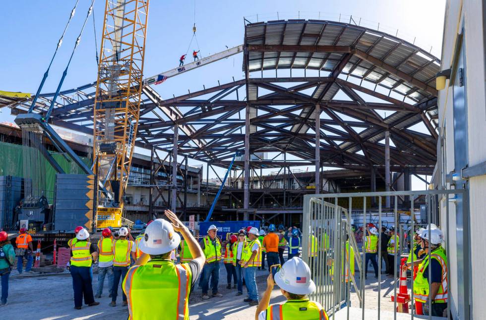 Workers prepare to remove the cables after securing the beam into place as the Las Vegas Conven ...